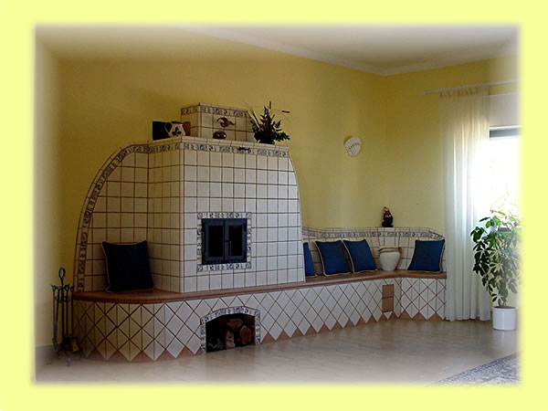 Dieser schöne Kachelofen beheizt eine Sitzbank und versorgt über einen Wärmeaustauscher die Zentralheizung des Hauses